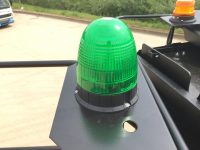 wheeled excavator hire with green seat belt beacon